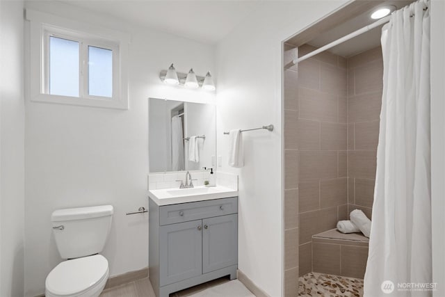 921 Autumn Ln Unit 205, Bellingham, WA 98229 - bathroom with a tile shower, toilet, vanity, and baseboards