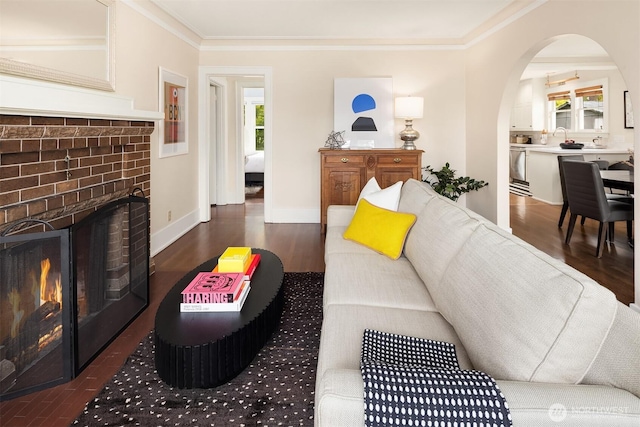 4529 Eastern Ave N, Seattle, WA 98103 - living area featuring arched walkways, crown molding, a fireplace, wood finished floors, and baseboards
