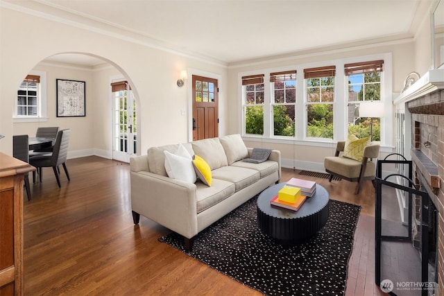 4529 Eastern Ave N, Seattle, WA 98103 - living area with a brick fireplace, arched walkways, wood finished floors, baseboards, and ornamental molding