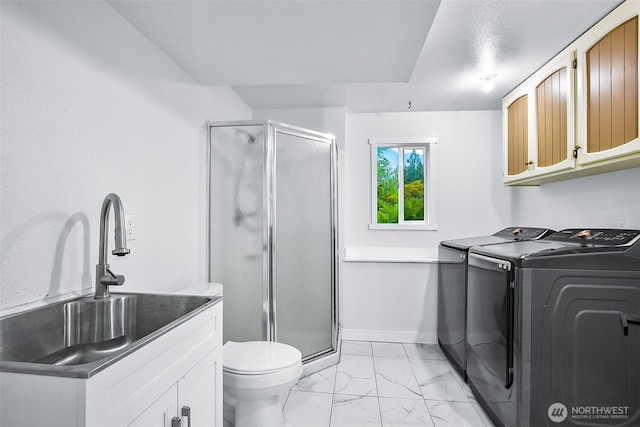 8029 Crown Ridge Blvd, Arlington, WA 98223 - bathroom featuring washing machine and clothes dryer, marble finish flooring, a stall shower, and baseboards