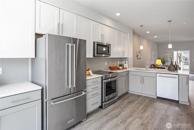 825 238th Pl SE Unit D, Bothell, WA 98021 - kitchen with stainless steel appliances, a sink, light wood-type flooring, recessed lighting, and backsplash
