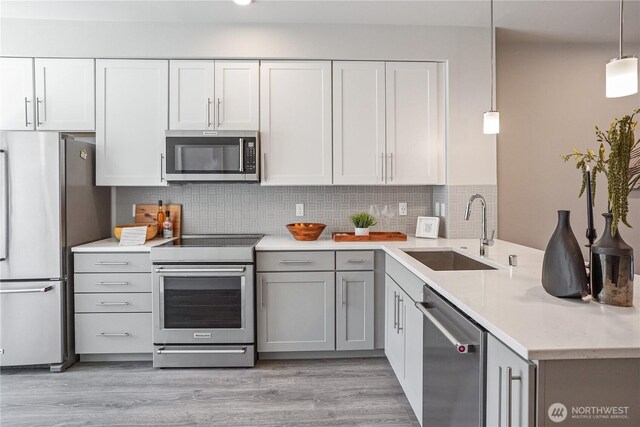 825 238th Pl SE Unit D, Bothell, WA 98021 - kitchen featuring appliances with stainless steel finishes, a sink, light wood-style floors, gray cabinets, and recessed lighting