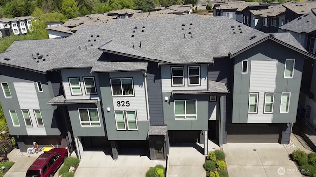 825 238th Pl SE Unit D, Bothell, WA 98021 - view of front facade with an attached garage, a shingled roof, driveway, and a residential view
