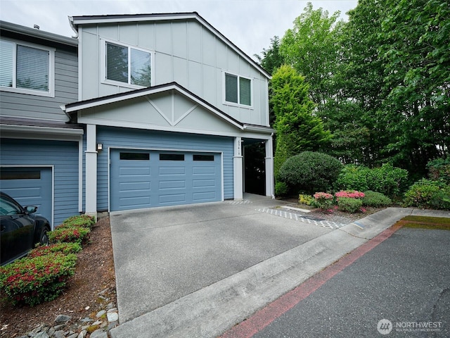 6941 134th Ct SE Unit B, Newcastle, WA 98059 - view of front of house featuring an attached garage, board and batten siding, and driveway
