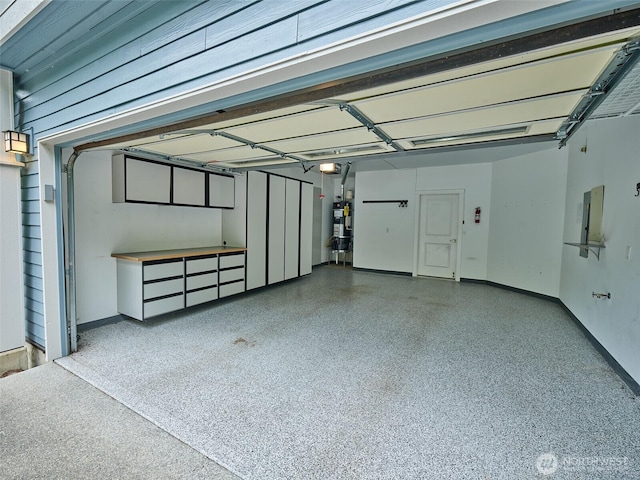 6941 134th Ct SE Unit B, Newcastle, WA 98059 - garage with a garage door opener, water heater, baseboards, and electric panel
