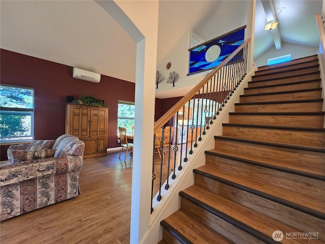 staircase with a wall unit AC, wood finished floors, beam ceiling, arched walkways, and high vaulted ceiling