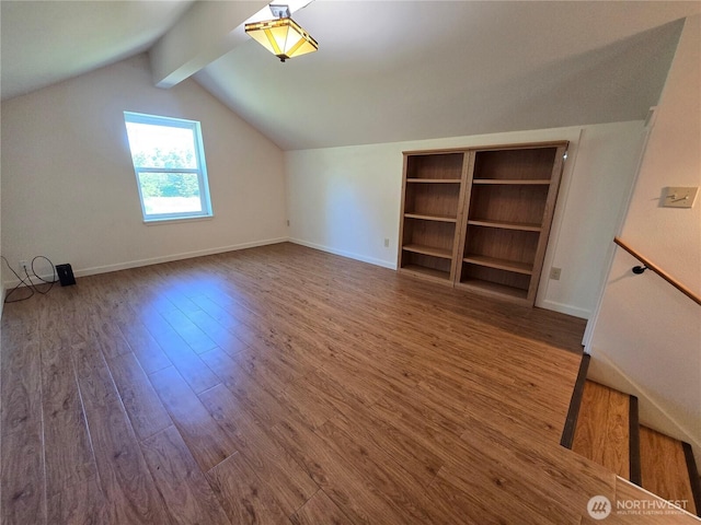 bonus room with wood finished floors and baseboards