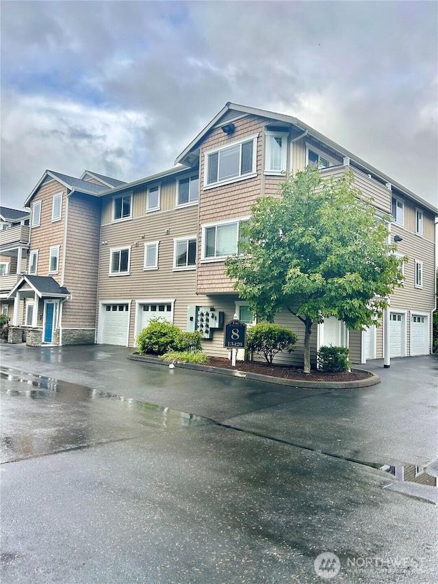 13426 97th Ave E Unit 301, Puyallup, WA 98373 - view of front of home featuring a garage and driveway