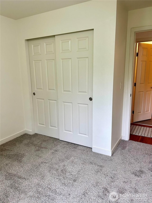 13426 97th Ave E Unit 301, Puyallup, WA 98373 - unfurnished bedroom with carpet flooring, baseboards, and a closet