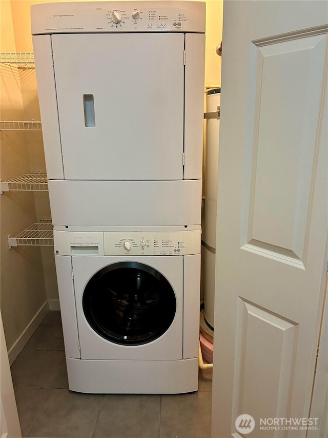 13426 97th Ave E Unit 301, Puyallup, WA 98373 - clothes washing area with stacked washer and clothes dryer, tile patterned floors, and water heater