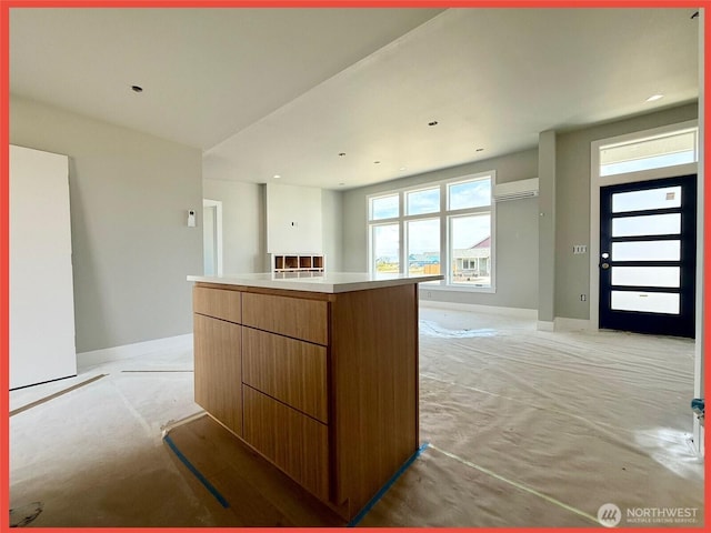 455 N Portal Loop SW, Ocean Shores, WA 98569 - kitchen with light colored carpet, baseboards, a center island, open floor plan, and recessed lighting