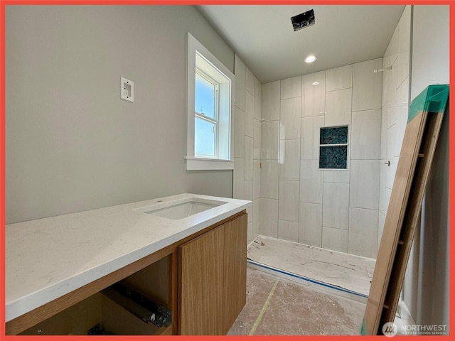 455 N Portal Loop SW, Ocean Shores, WA 98569 - bathroom featuring tiled shower, vanity, concrete flooring, and recessed lighting