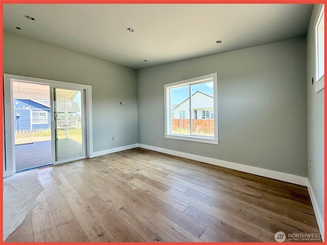 455 N Portal Loop SW, Ocean Shores, WA 98569 - spare room featuring plenty of natural light, baseboards, and wood finished floors