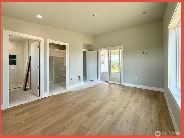 455 N Portal Loop SW, Ocean Shores, WA 98569 - unfurnished bedroom with light wood-type flooring, baseboards, a spacious closet, access to outside, and recessed lighting