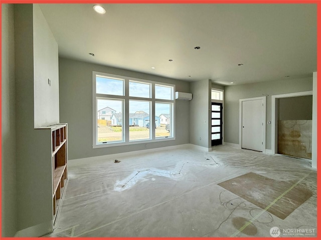 455 N Portal Loop SW, Ocean Shores, WA 98569 - unfurnished living room with a wall mounted air conditioner, baseboards, and recessed lighting