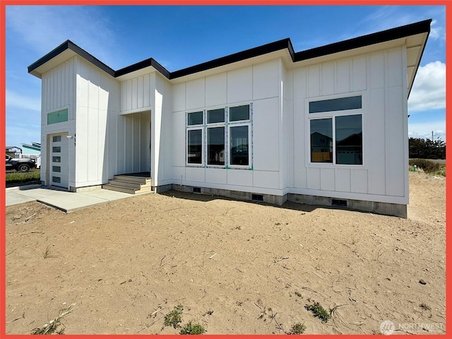 455 N Portal Loop SW, Ocean Shores, WA 98569 - rear view of house featuring crawl space, board and batten siding, and a garage