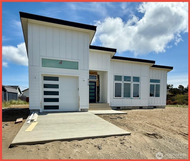 455 N Portal Loop SW, Ocean Shores, WA 98569 - view of front of property with crawl space, board and batten siding, and driveway