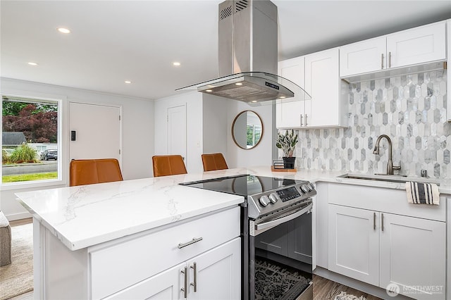 5705 241st St SW, Mountlake Terrace, WA 98043 - kitchen with electric stove, island range hood, a peninsula, tasteful backsplash, and white cabinets