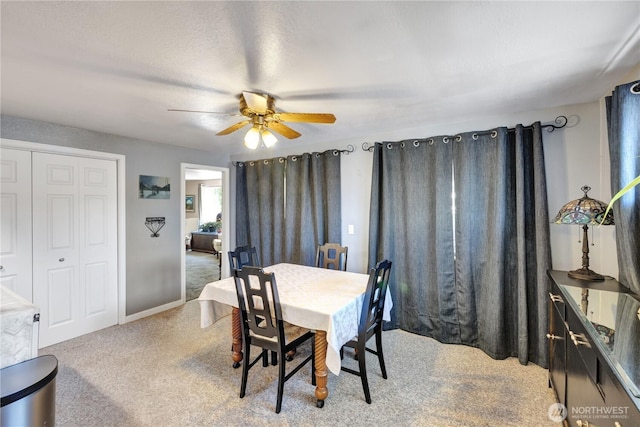 10208 28th Ave SW, Seattle, WA 98146 - dining room featuring carpet floors, a ceiling fan, and baseboards