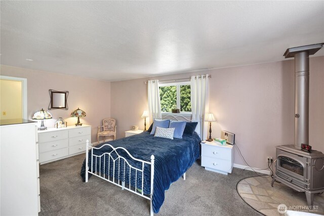 10208 28th Ave SW, Seattle, WA 98146 - bedroom featuring carpet and a wood stove