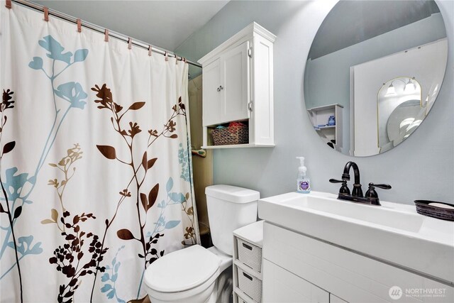 10208 28th Ave SW, Seattle, WA 98146 - bathroom with toilet, vanity, and a shower with shower curtain