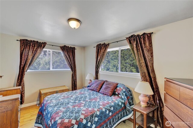 10208 28th Ave SW, Seattle, WA 98146 - bedroom featuring light wood-type flooring and baseboards