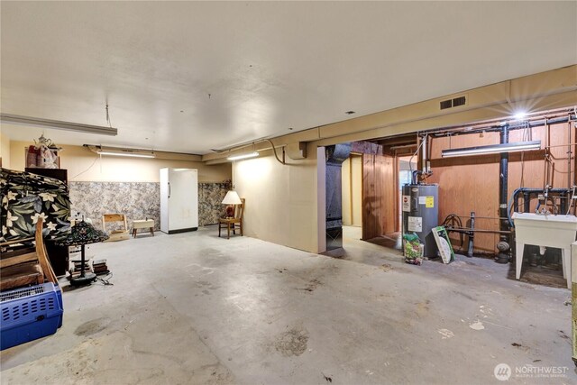 10208 28th Ave SW, Seattle, WA 98146 - unfinished below grade area featuring water heater and a sink