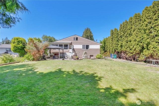 10208 28th Ave SW, Seattle, WA 98146 - rear view of property with a gazebo, a lawn, and a patio