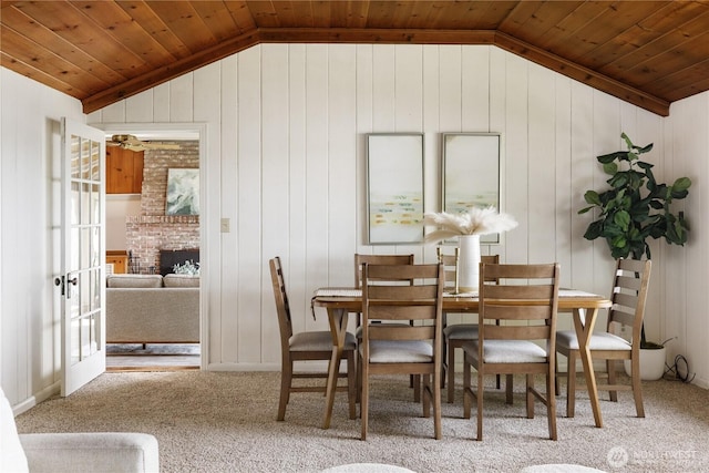 3115 Saratoga Rd, Langley, WA 98260 - carpeted dining room with vaulted ceiling, wooden ceiling, wooden walls, and a fireplace