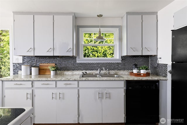 3115 Saratoga Rd, Langley, WA 98260 - kitchen with black appliances, a sink, tasteful backsplash, white cabinets, and decorative light fixtures