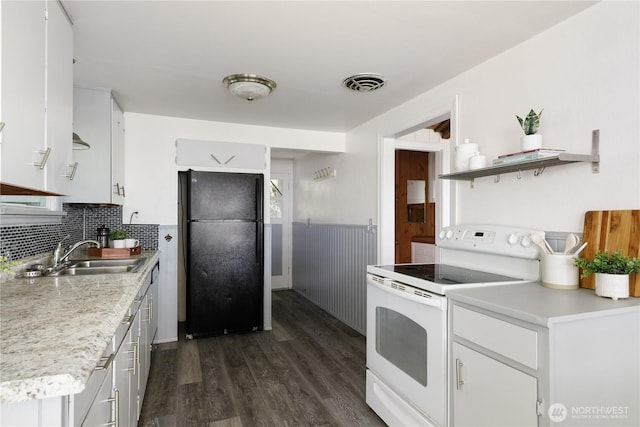 3115 Saratoga Rd, Langley, WA 98260 - kitchen with freestanding refrigerator, white range with electric cooktop, a sink, dark wood finished floors, and open shelves