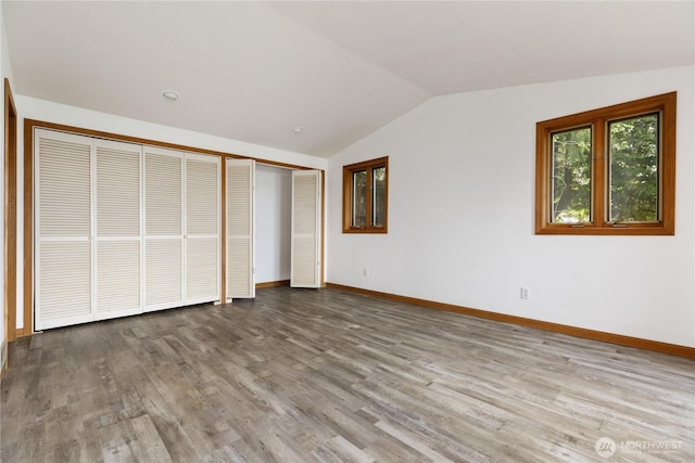 3115 Saratoga Rd, Langley, WA 98260 - unfurnished bedroom featuring vaulted ceiling, baseboards, wood finished floors, and a closet