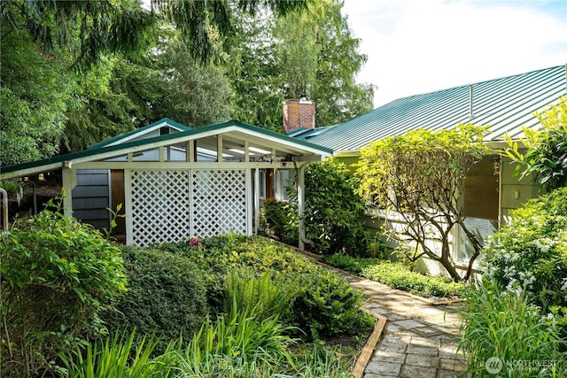 3115 Saratoga Rd, Langley, WA 98260 - view of home's exterior featuring a chimney, a standing seam roof, and metal roof