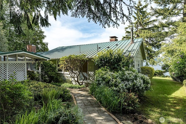 3115 Saratoga Rd, Langley, WA 98260 - rear view of property with a standing seam roof, a chimney, metal roof, and a yard