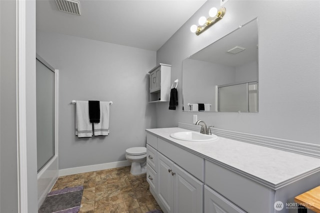 1032 Edgewater Ln, Moses Lake, WA 98837 - bathroom with stone finish floors, baseboards, vanity, and toilet