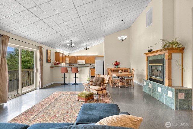 5380 Marshall Hill Rd, Deming, WA 98244 - living area featuring a chandelier, baseboards, a fireplace, and high vaulted ceiling