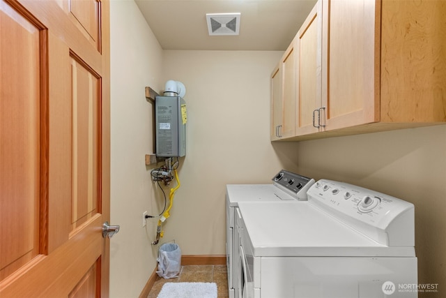 703 S Sand Dune Ave SW, Ocean Shores, WA 98569 - laundry area featuring separate washer and dryer, cabinet space, baseboards, and tile patterned floors