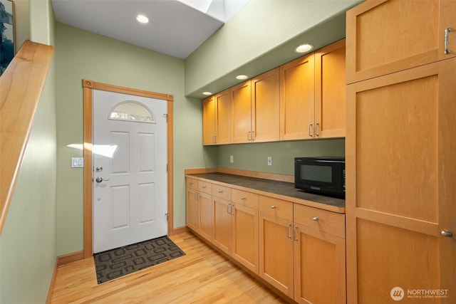 703 S Sand Dune Ave SW, Ocean Shores, WA 98569 - kitchen with black microwave, light wood-style floors, recessed lighting, baseboards, and dark countertops