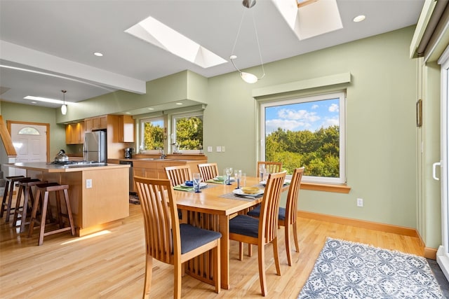 703 S Sand Dune Ave SW, Ocean Shores, WA 98569 - dining room featuring a skylight, light wood-style floors, baseboards, and recessed lighting