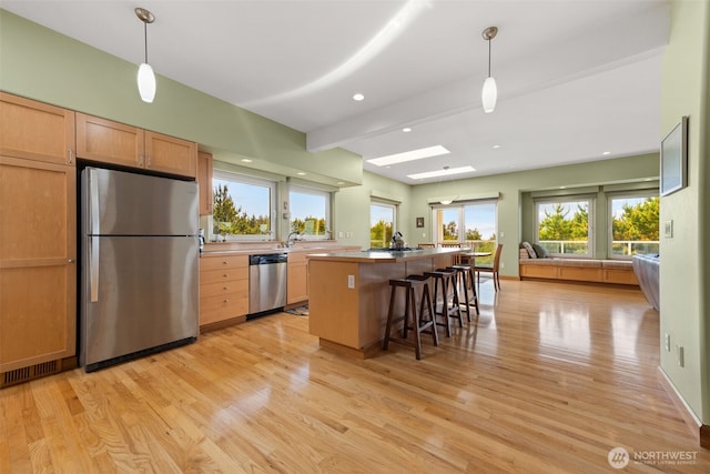 703 S Sand Dune Ave SW, Ocean Shores, WA 98569 - kitchen featuring appliances with stainless steel finishes, open floor plan, light wood-style floors, a center island with sink, and recessed lighting