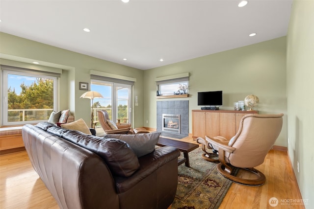 703 S Sand Dune Ave SW, Ocean Shores, WA 98569 - living area with light wood finished floors, a tile fireplace, plenty of natural light, recessed lighting, and baseboards