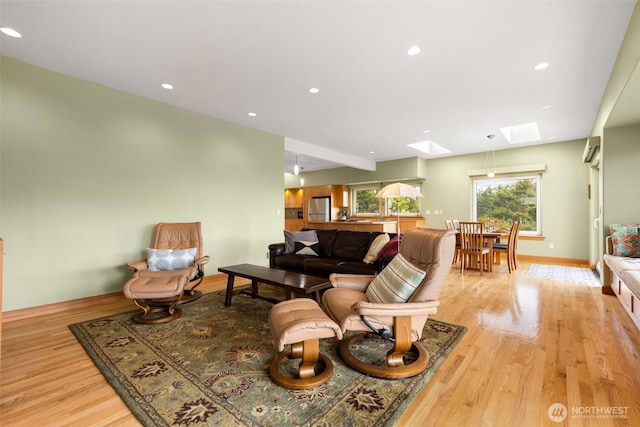 703 S Sand Dune Ave SW, Ocean Shores, WA 98569 - living area featuring a skylight, light wood-style flooring, baseboards, and recessed lighting