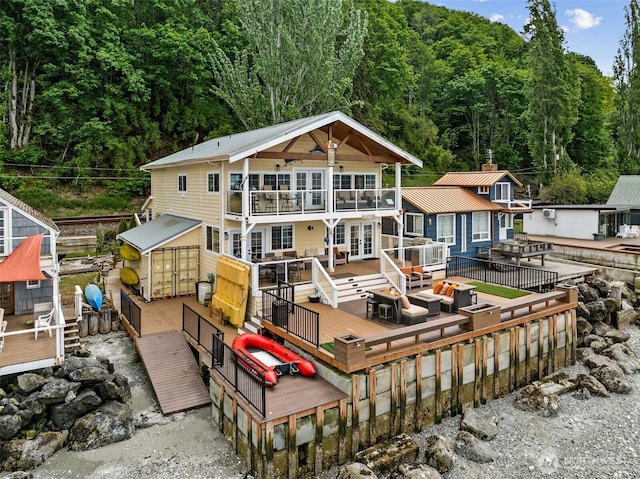 8116 Naketa Beach Walk, Mukilteo, WA 98275 - back of property featuring a wooden deck, a balcony, french doors, and a wooded view