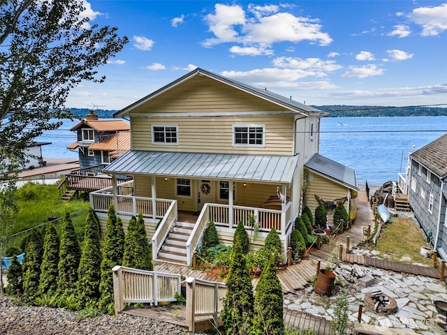 8116 Naketa Beach Walk, Mukilteo, WA 98275 - view of front of property with stairs, a water view, a standing seam roof, and metal roof