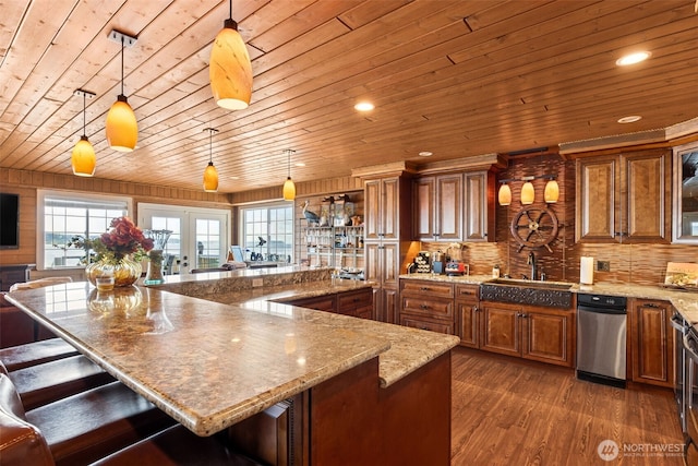 8116 Naketa Beach Walk, Mukilteo, WA 98275 - kitchen featuring wooden ceiling, a sink, brown cabinets, a kitchen bar, and pendant lighting