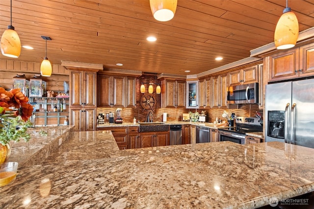 8116 Naketa Beach Walk, Mukilteo, WA 98275 - kitchen with appliances with stainless steel finishes, brown cabinetry, a sink, backsplash, and light stone counters