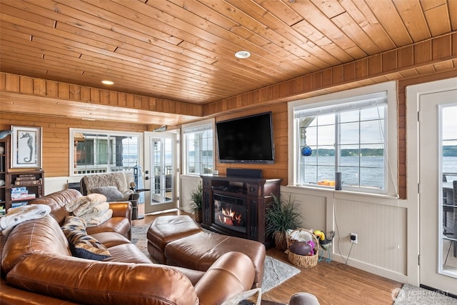 8116 Naketa Beach Walk, Mukilteo, WA 98275 - living area featuring wooden ceiling, french doors, a glass covered fireplace, wood finished floors, and wood walls