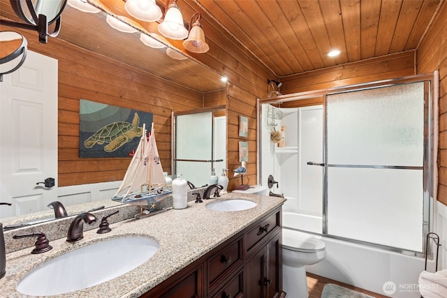 8116 Naketa Beach Walk, Mukilteo, WA 98275 - bathroom with wood walls, toilet, double vanity, wood ceiling, and bath / shower combo with glass door