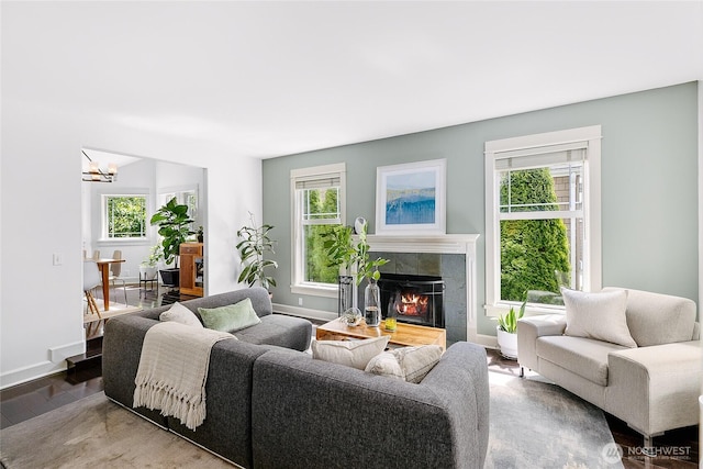 1014 Cherry Ave NE, Bainbridge Island, WA 98110 - living room with a tile fireplace, wood finished floors, a chandelier, and baseboards