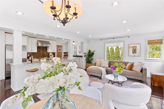 1014 Cherry Ave NE, Bainbridge Island, WA 98110 - living area with dark wood-style floors, healthy amount of natural light, recessed lighting, baseboards, and a chandelier